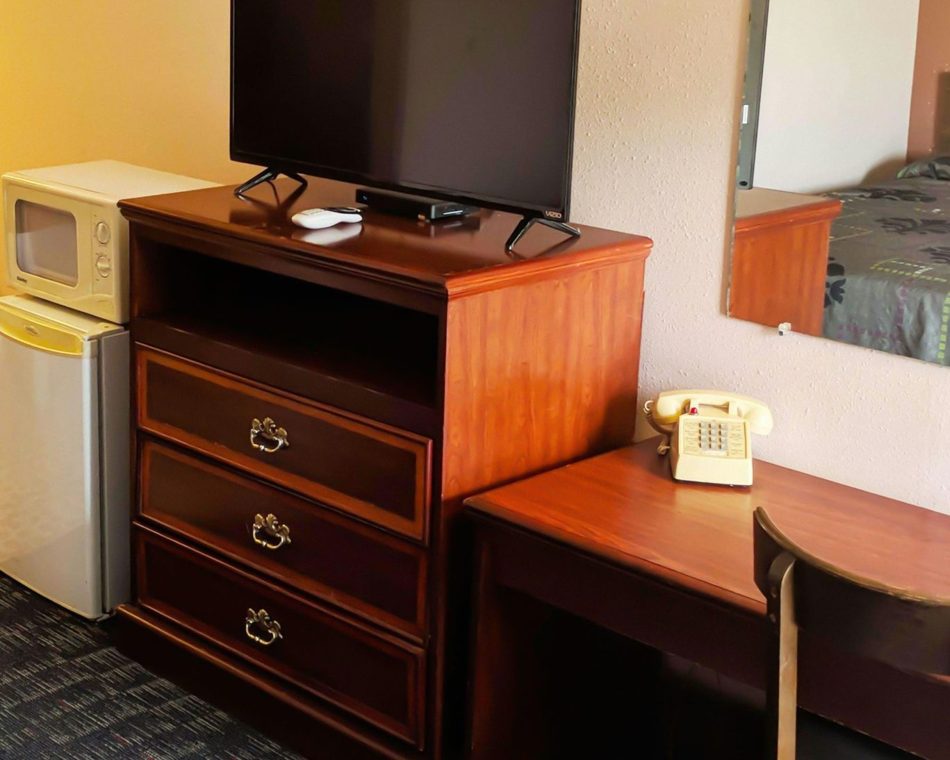 In-room amenities at Black Angus Motel including TV, mini fridge, and microwave.
