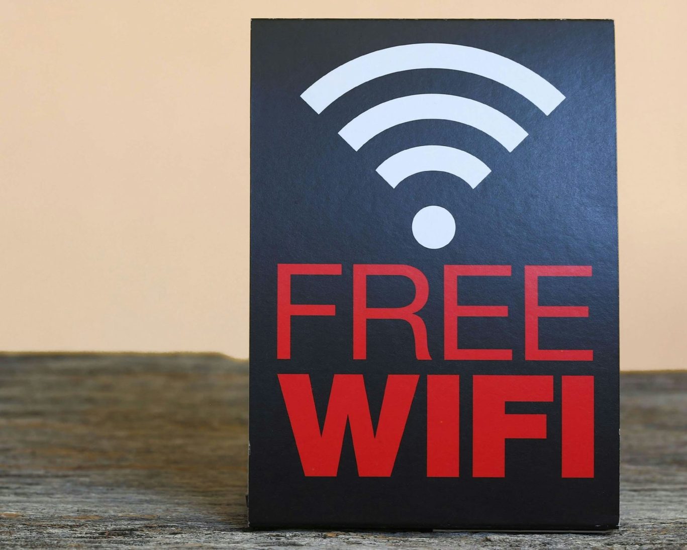 Free Wi-Fi sign on wooden table at Colonial Motel for guest convenience.