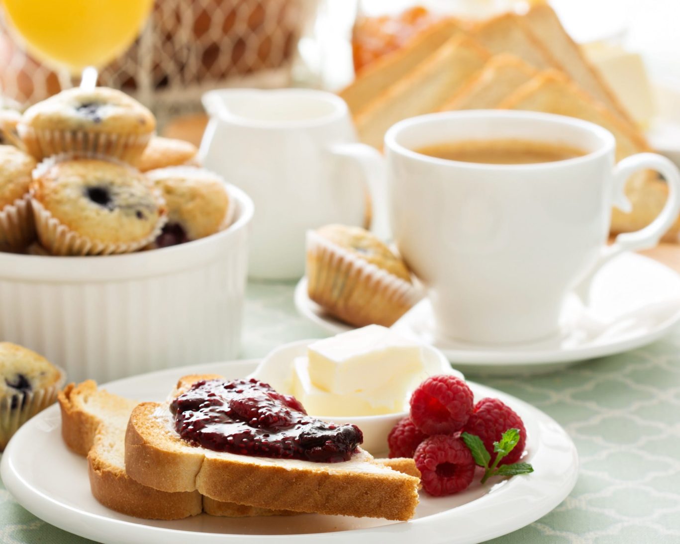 Continental breakfast with toast, jam, muffins, coffee, and fresh raspberries at Dodge Peak Lodge.