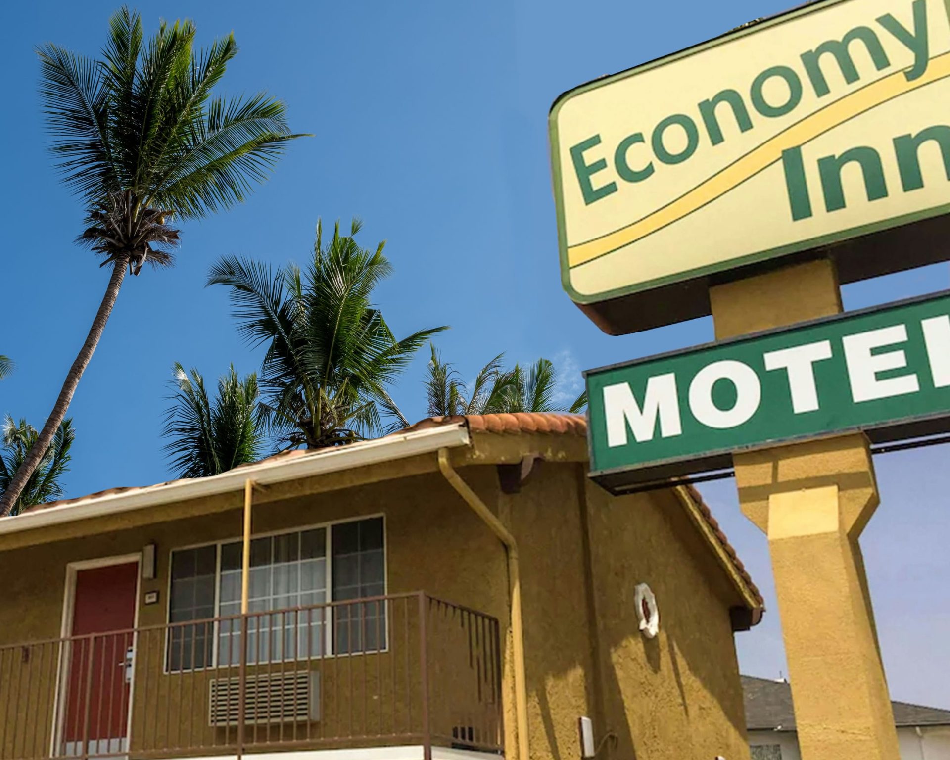 Economy Inn Sylmar exterior with motel sign and palm trees under clear blue sky.