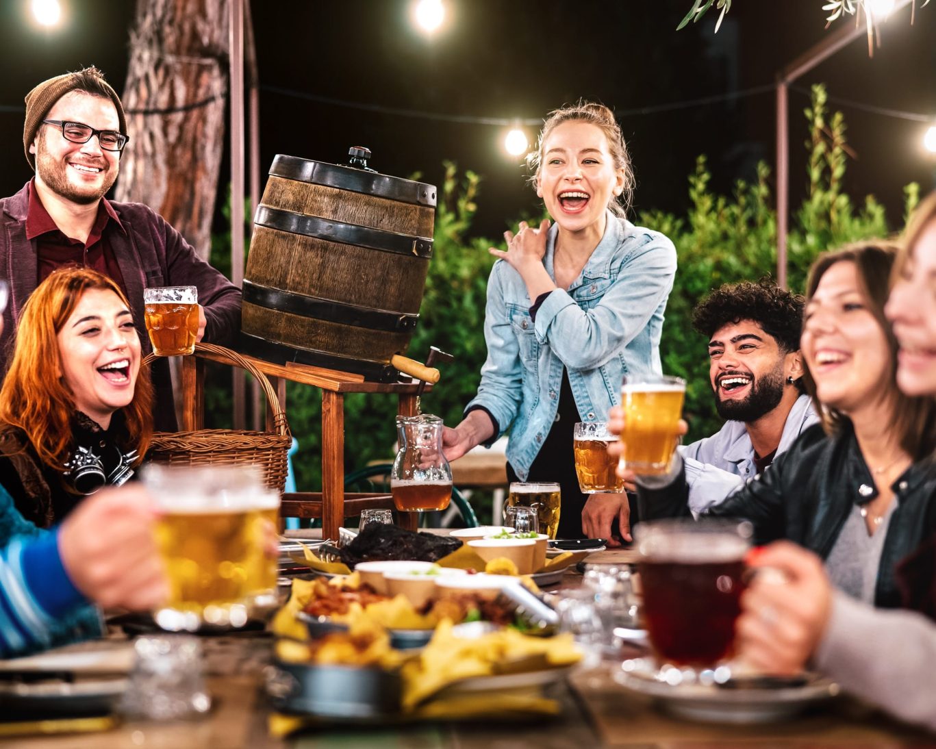 Friends enjoying craft beer and food at Stone Brewing’s outdoor garden in Escondido, California.