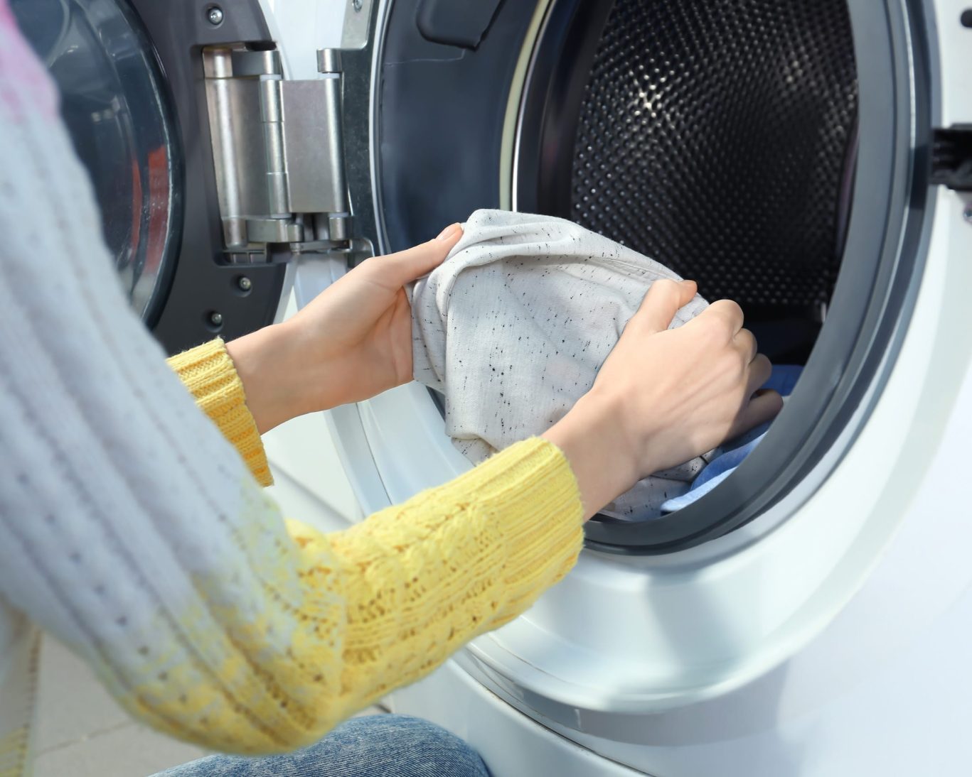 Guest using laundry facilities at Express Inn Newport, offering convenient on-site washer and dryer.