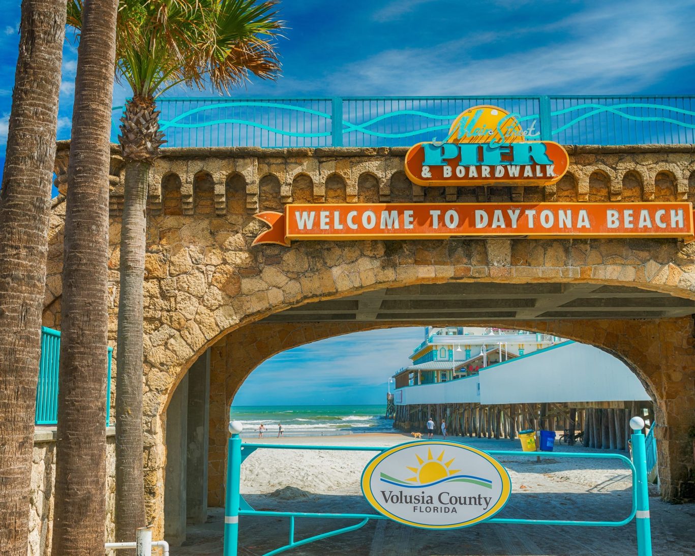 Main Street Pier and Boardwalk entrance sign welcoming visitors to Daytona Beach, Florida near Fountain Beach Resort.