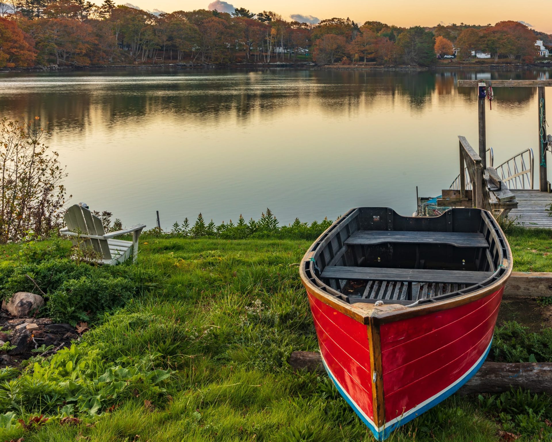 Red rowboat and Adirondack chair overlooking Milford Lake near Golden Wheat Motel.