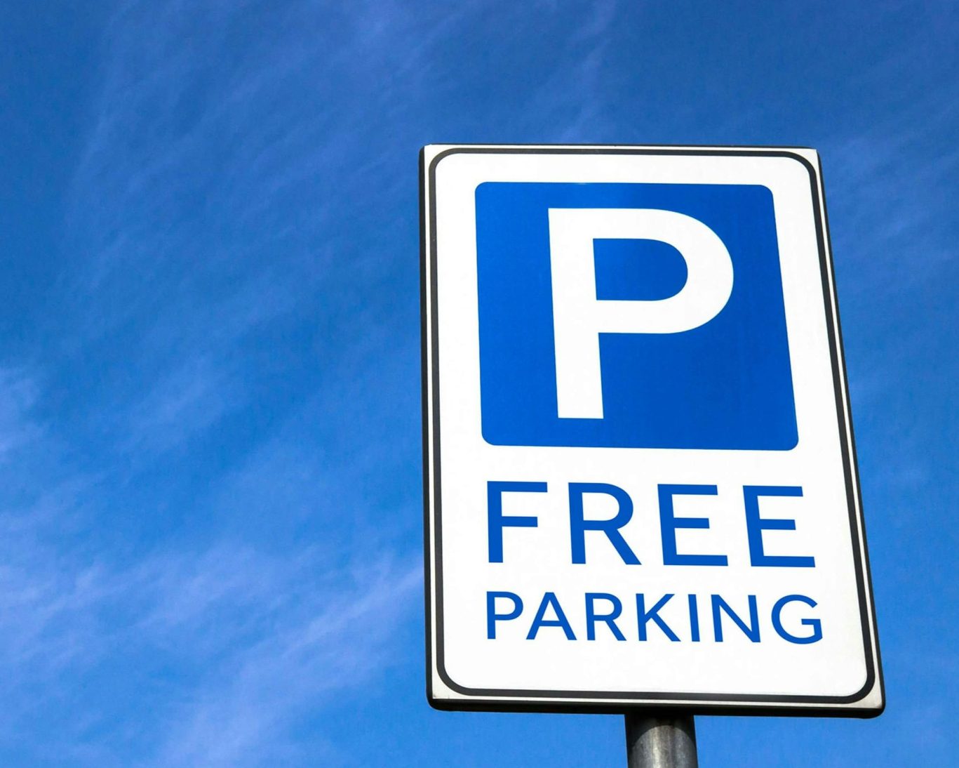 Free parking sign at Gray Inn offering convenient guest parking.