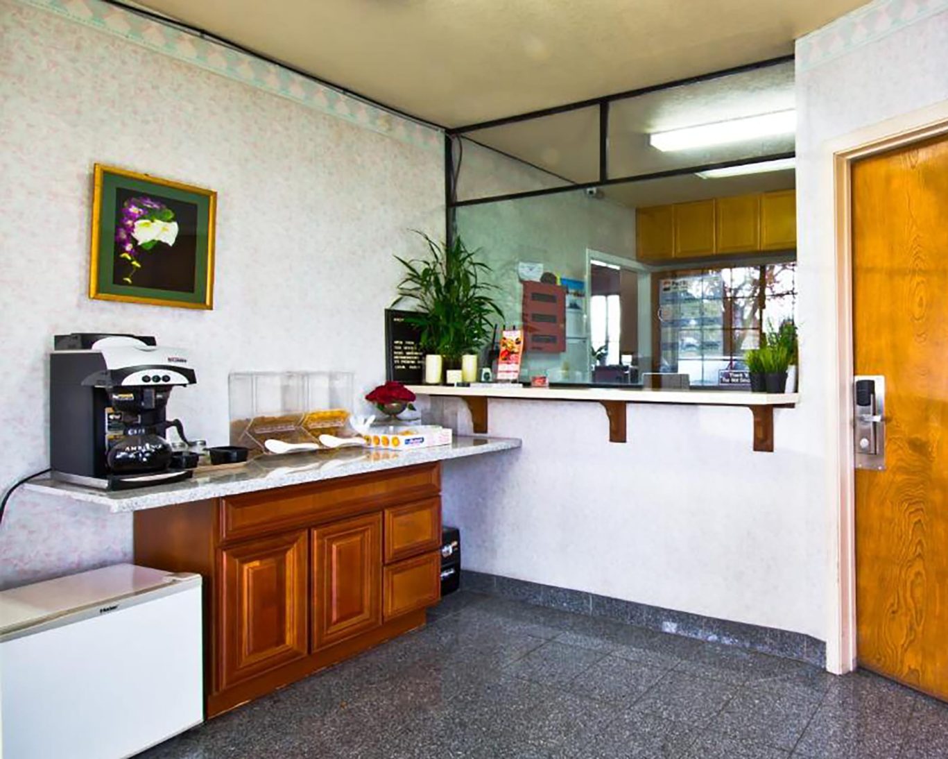 Valley Inn San Jose front desk and coffee station area with cereal dispensers and visitor amenities.