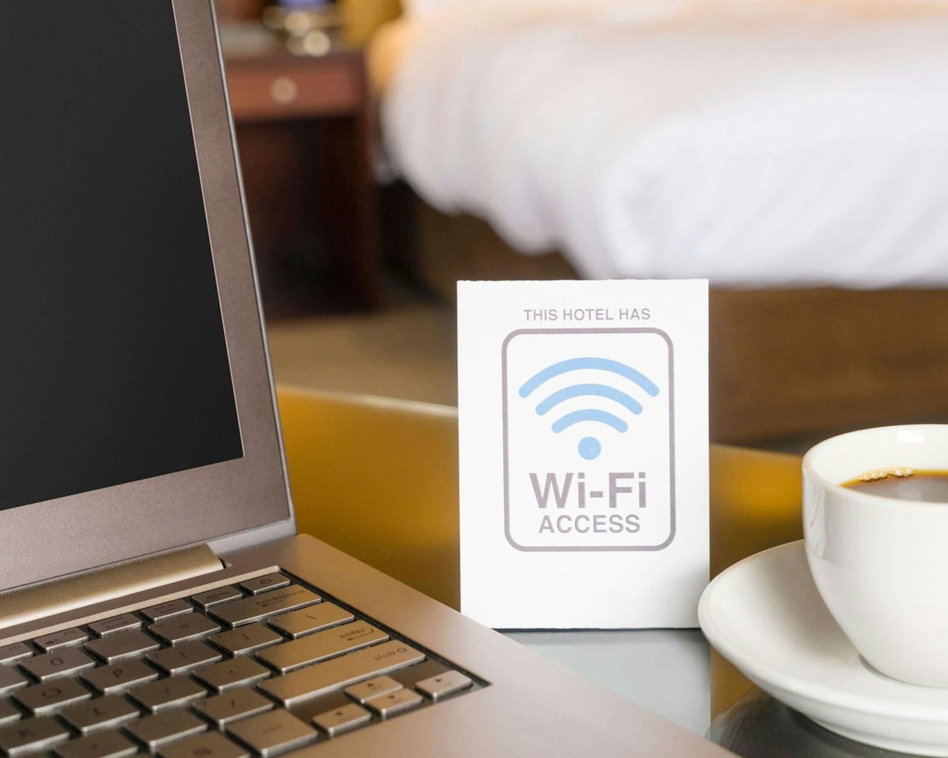 Free in-room Wi-Fi and workspace setup with coffee and laptop at Mountain Home Inn.