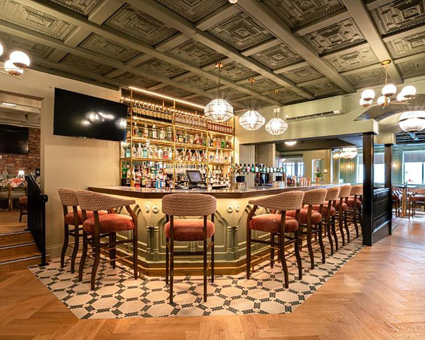 Stylish hotel bar at The Newgrange Hotel Navan with ornate ceiling, wooden flooring, and cushioned stools.