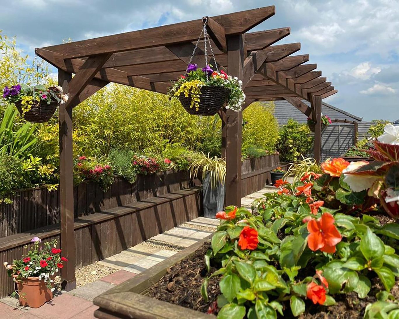 Rooftop pergola and flower garden at The Newgrange Hotel Navan with hanging baskets and raised planters.