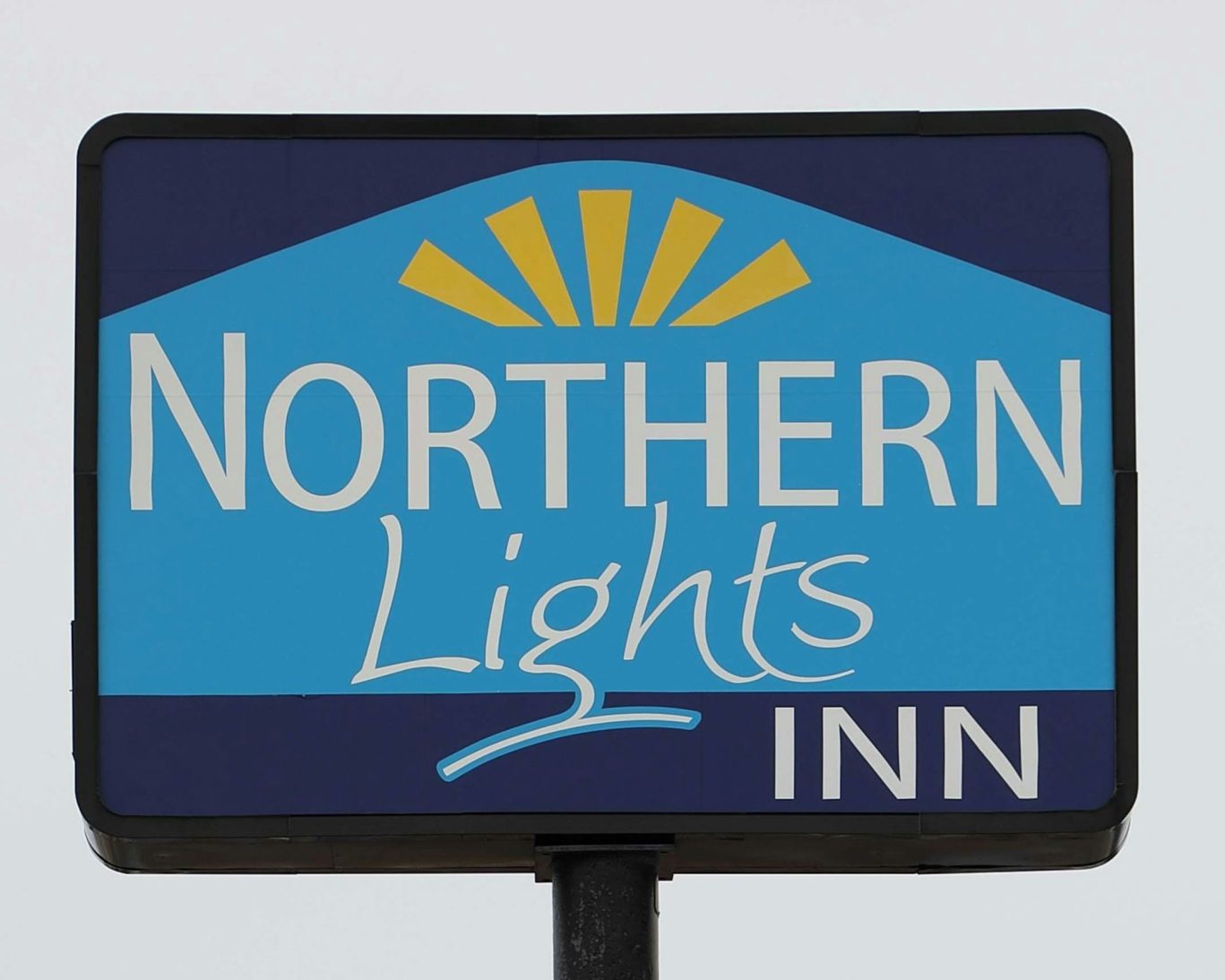 Northern Lights Inn roadside sign with blue and yellow design, welcoming guests to the property.