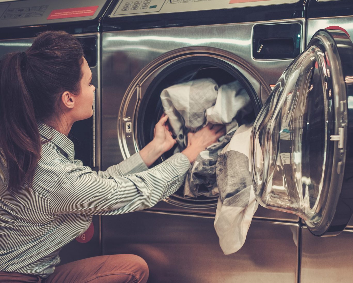 Guest using self-service laundry facilities at Oak Grove Inn, adding convenience for extended stays.