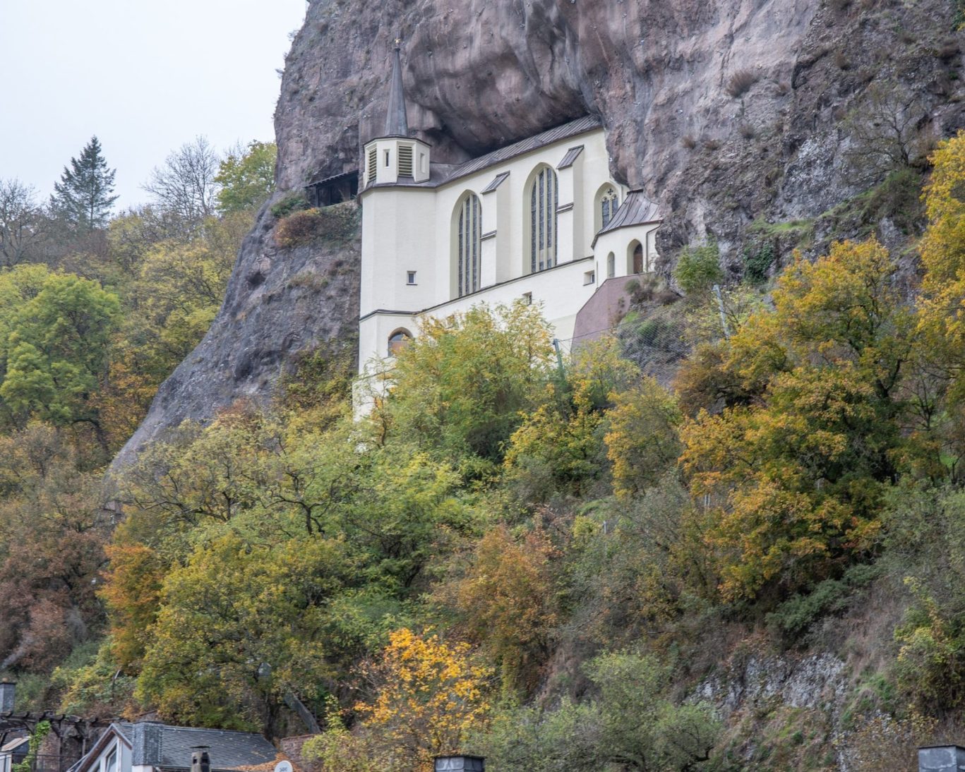 Historic Felsenkirche church built into the rock face above I.dar-Oberstein, surrounded by autumn trees