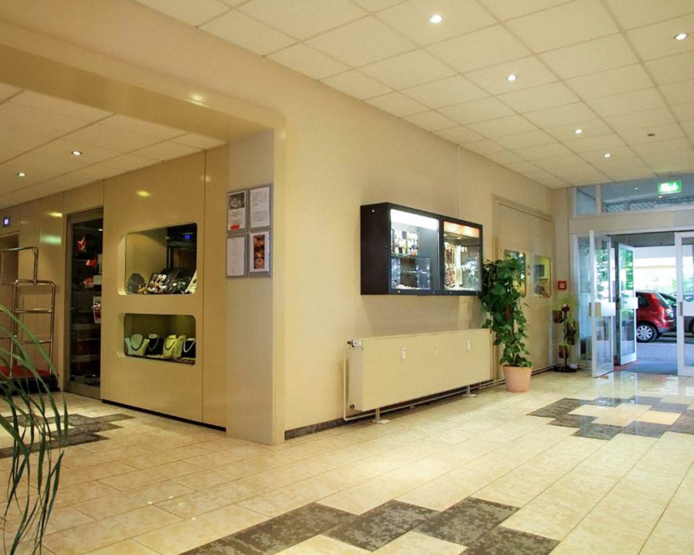 Spacious Opal Hotel lobby with jewelry display cases and tiled flooring in Bad Kreuznach.