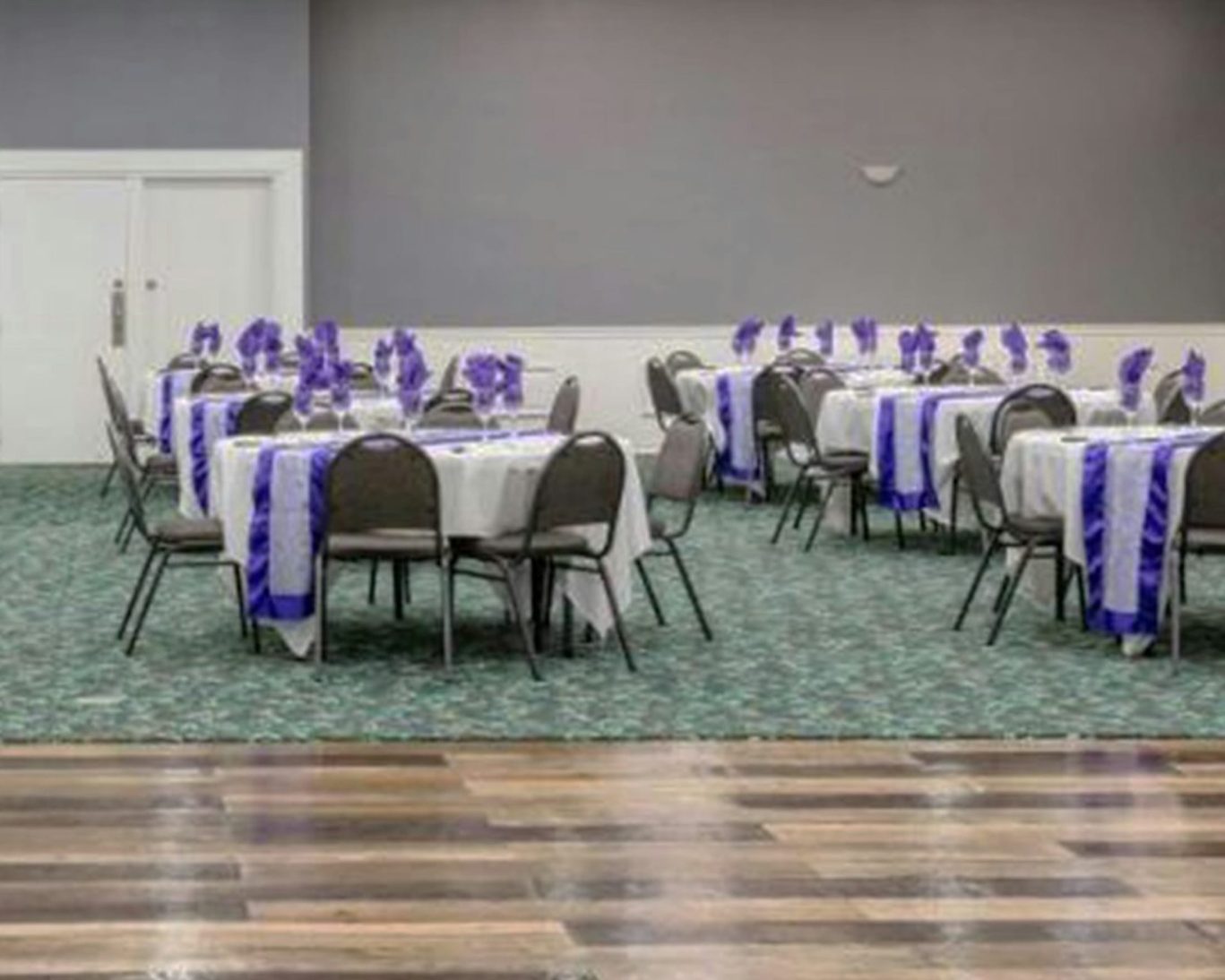 Elegant banquet and event hall at Pearl on the Concho Hotel in San Angelo, TX, set up for a formal gathering with purple-themed decor.