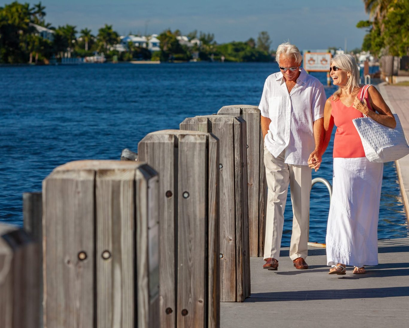 Senior couple walking along the scenic Concho River Walk in San Angelo, Texas, near Pearl on the Concho Hotel.