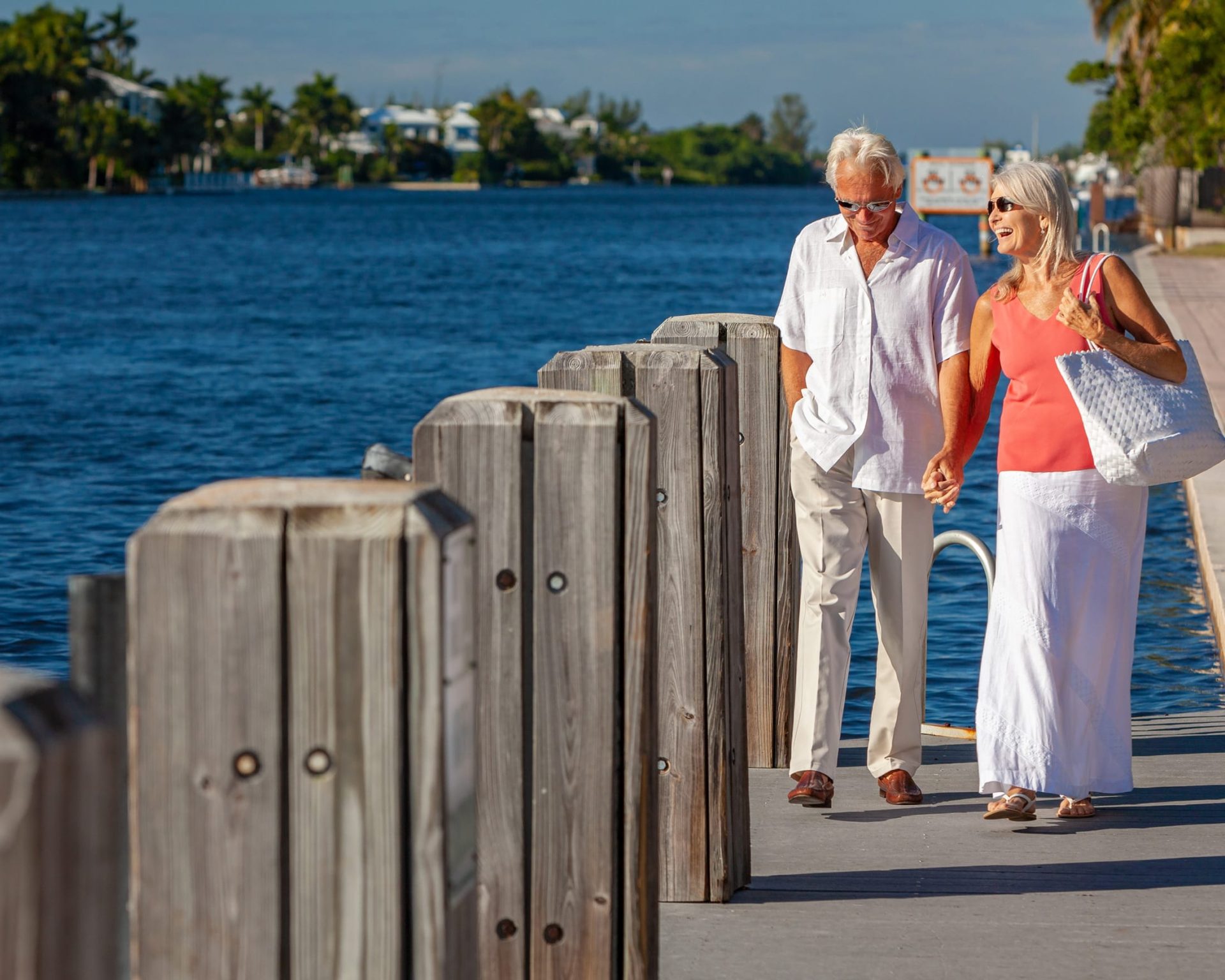 Senior couple walking along the scenic Concho River Walk in San Angelo, Texas, near Pearl on the Concho Hotel.