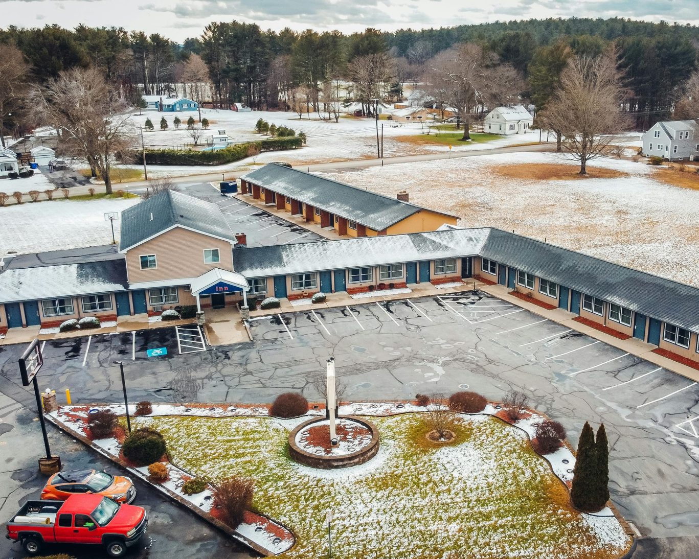 Aerial view of Quiet Corner Inn surrounded by light snow, motel in Brooklyn CT with ample parking.