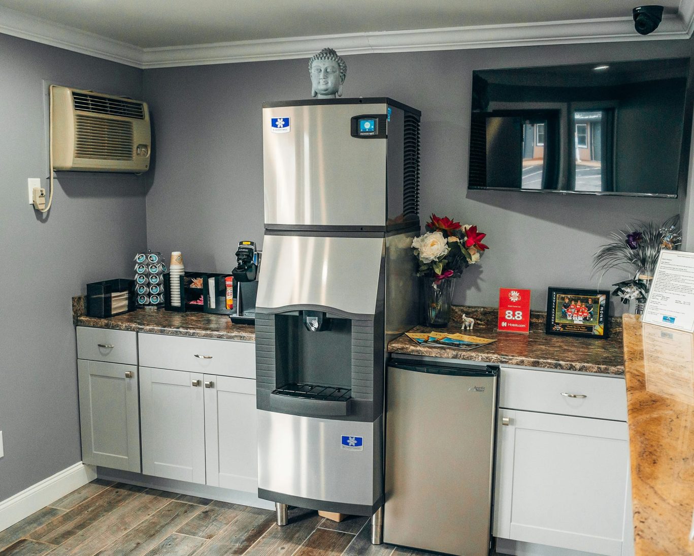 Guest refreshment area with ice machine, coffee station, and flowers at Quiet Corner Inn Brooklyn CT.