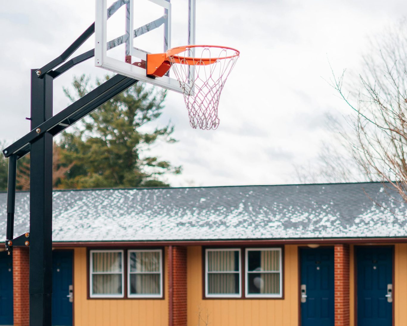 Outdoor basketball hoop in front of guest rooms at Quiet Corner Inn Brooklyn Connecticut.