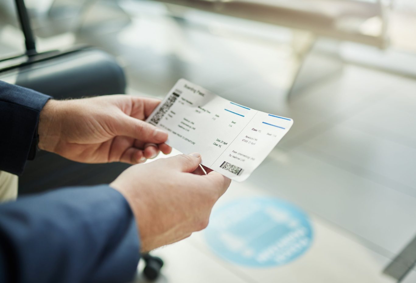 Traveler holding boarding pass at McKellar-Sipes Regional Airport in Jackson, Tennessee.