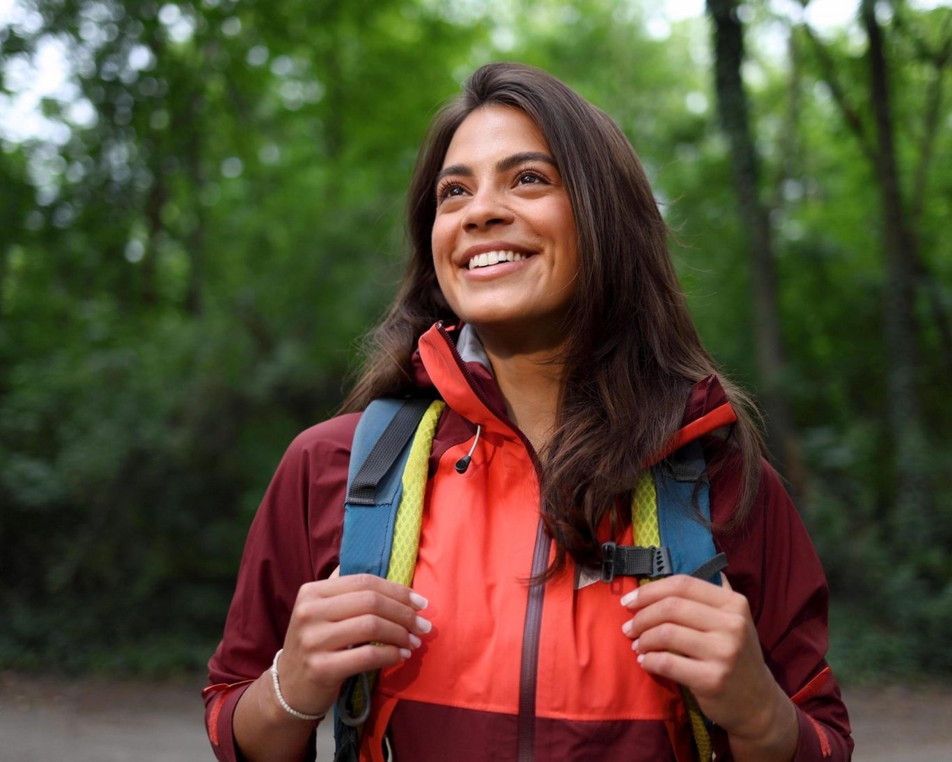Happy female hiker exploring the lush trails of Ricketts Glen State Park in Pennsylvania.