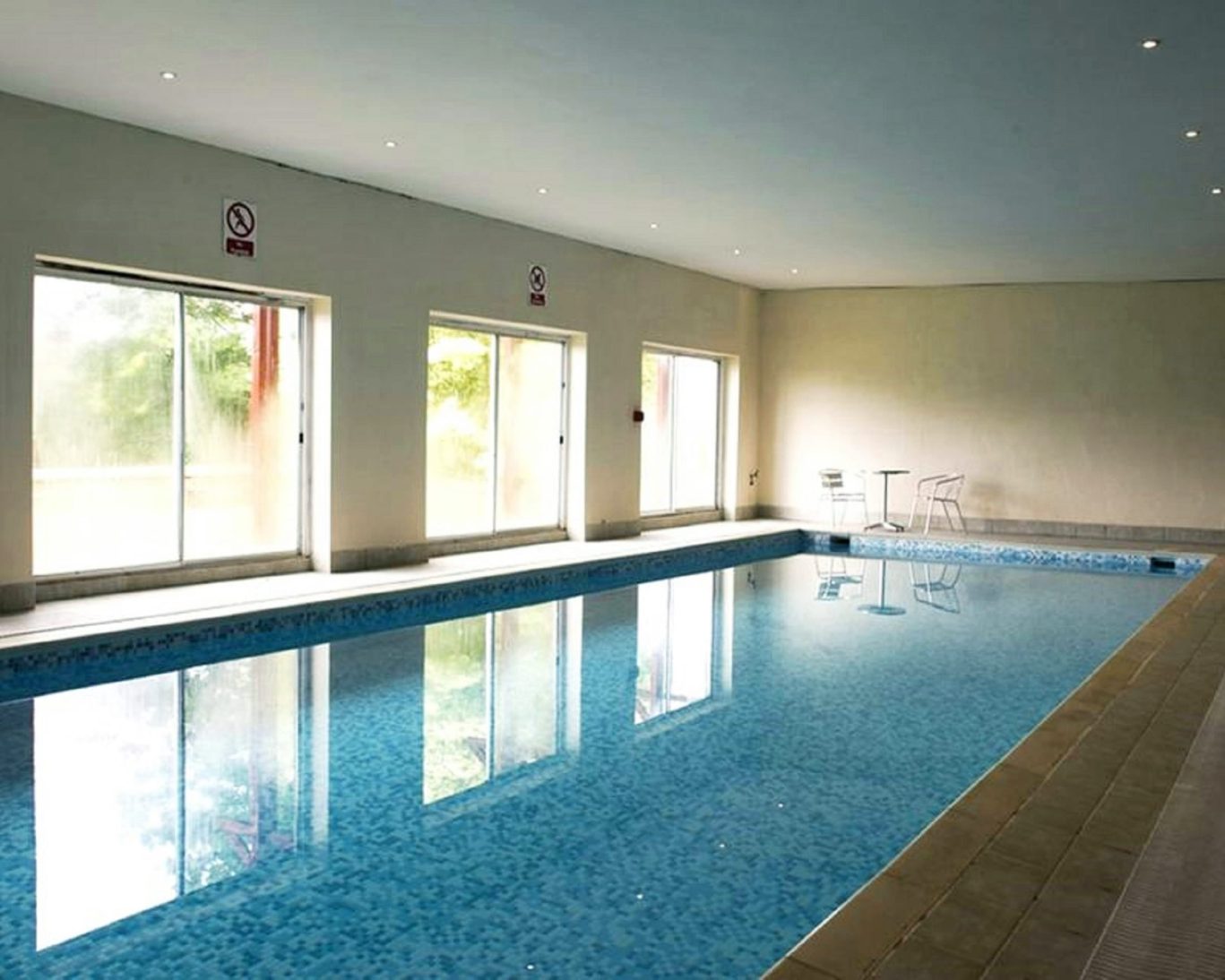 Indoor swimming pool at Riverdale Hall Hotel with natural light from large windows.