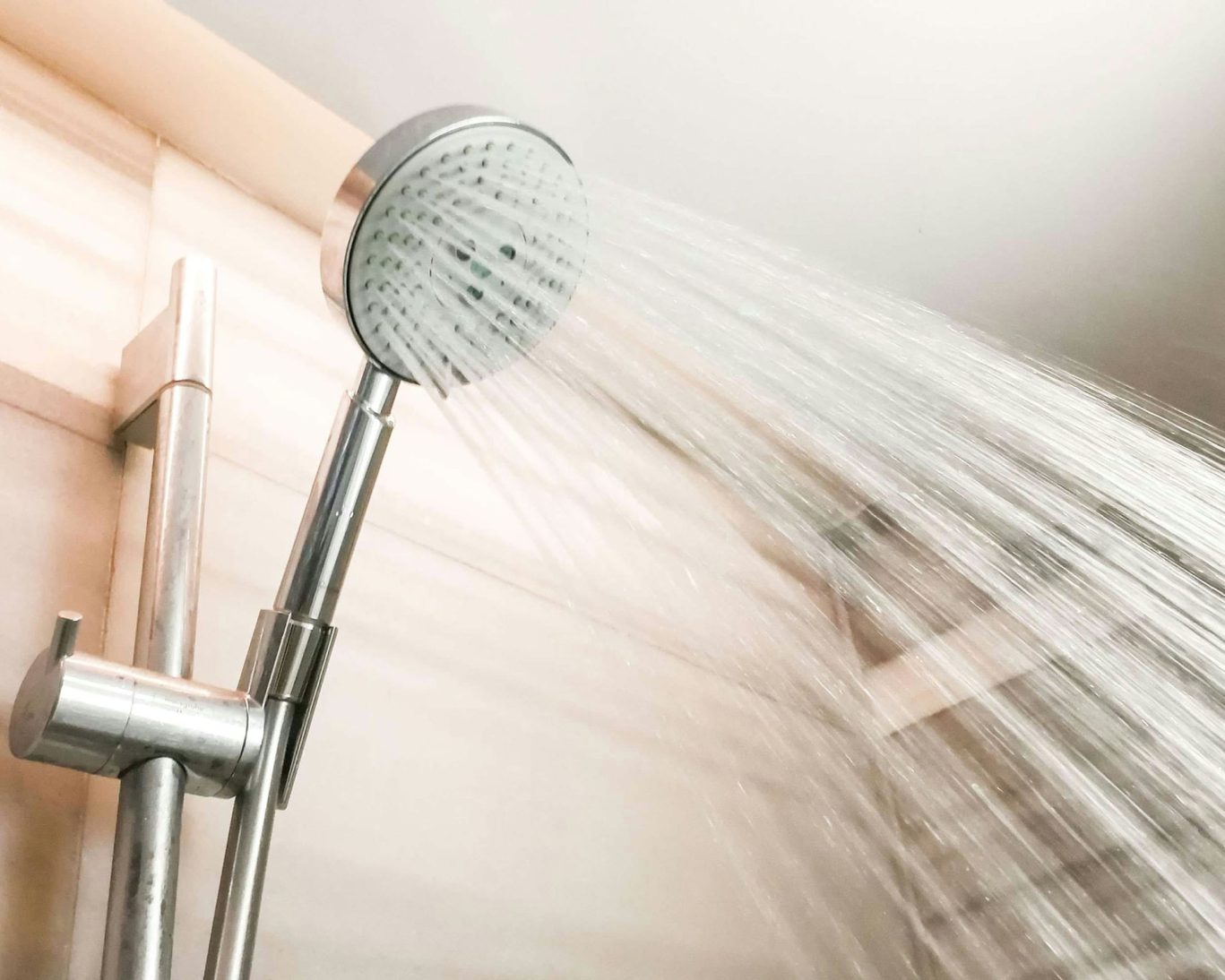 Modern handheld showerhead with strong water pressure at Santa Cruz Inn Riverside.