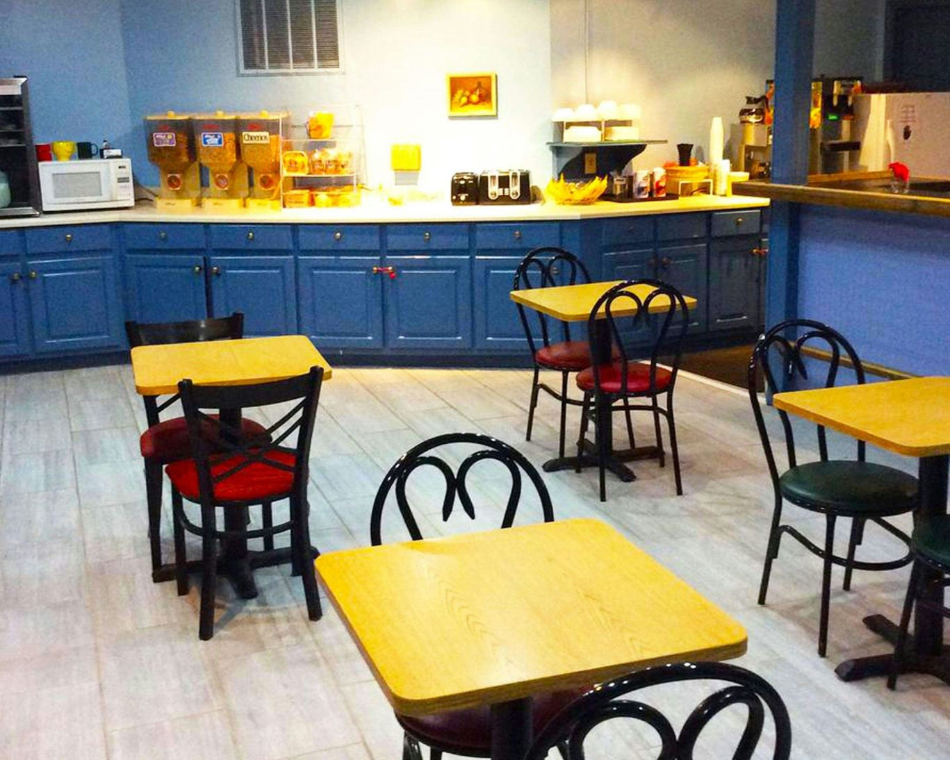 Cozy breakfast room at Stratford Motor Inn East Ellijay with self-serve cereal and coffee station.