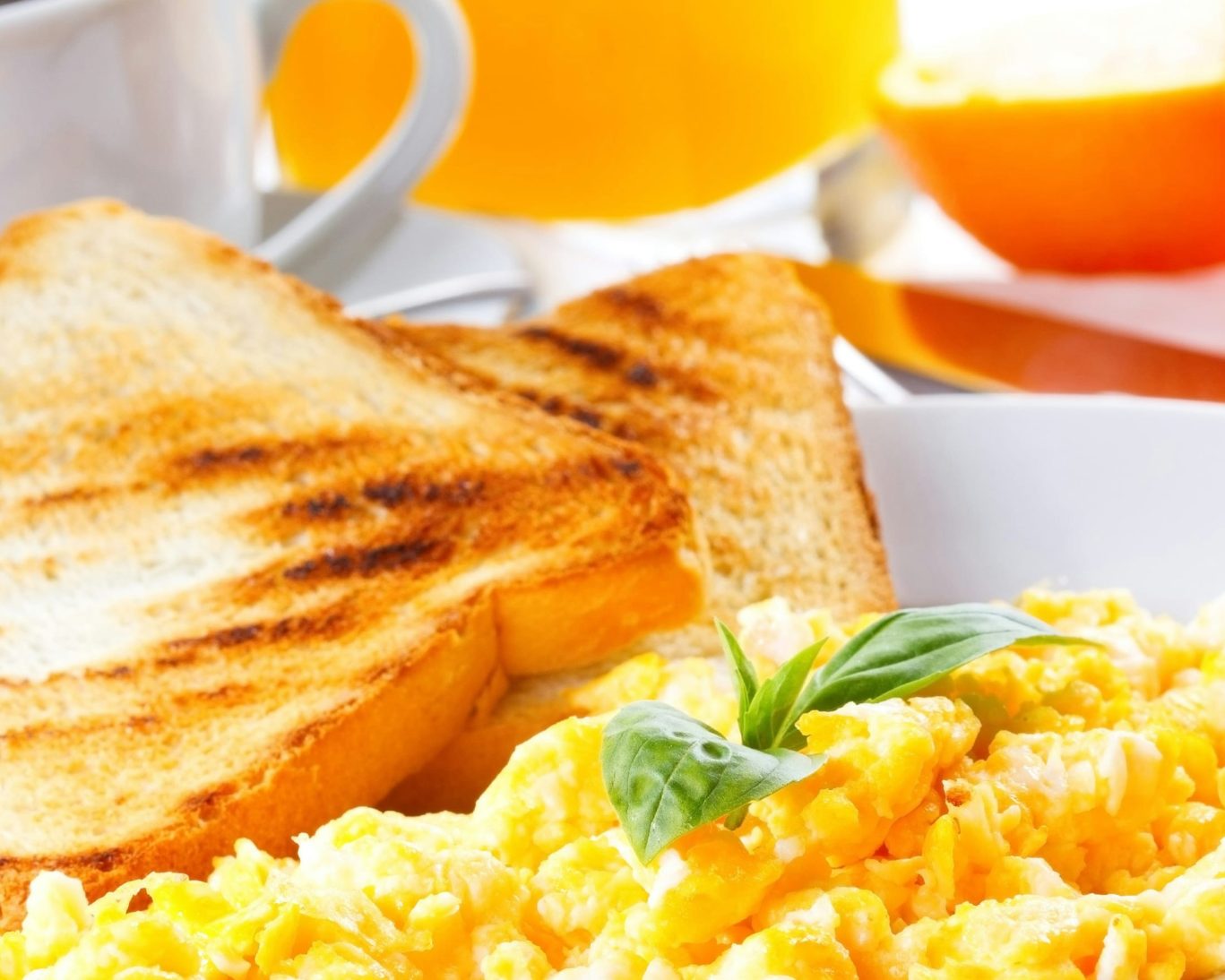 Complimentary hotel breakfast with scrambled eggs, toast, coffee, and orange juice at Super Inn and Suites Philadelphia.