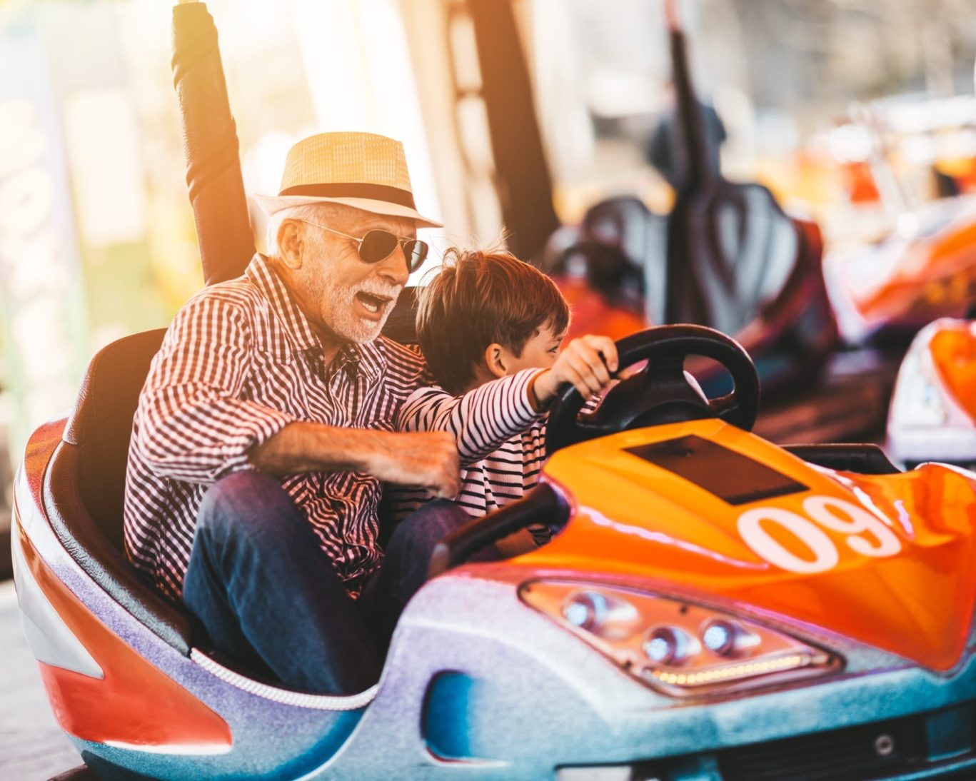 Grandfather and grandson enjoying bumper cars at California’s Gre.at America amusement park in Santa Clara