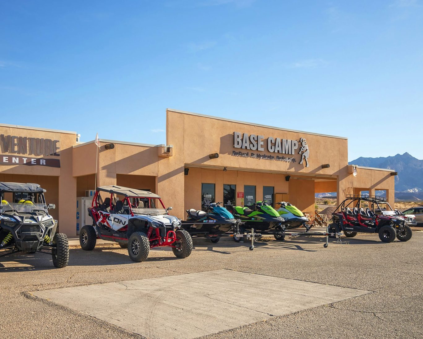 ATVs and jet skis parked in front of Base Camp Adventure Center at Ticaboo Lodge, Utah.