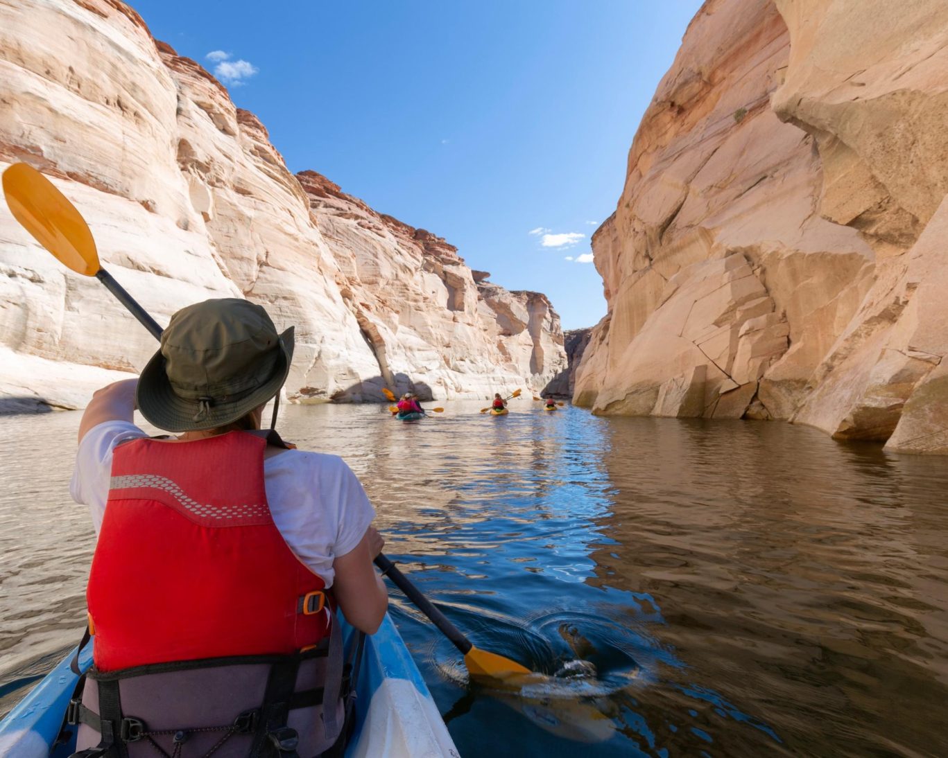 Group kayaking .adventure through scenic sandstone canyons on Lake Powell, Utah