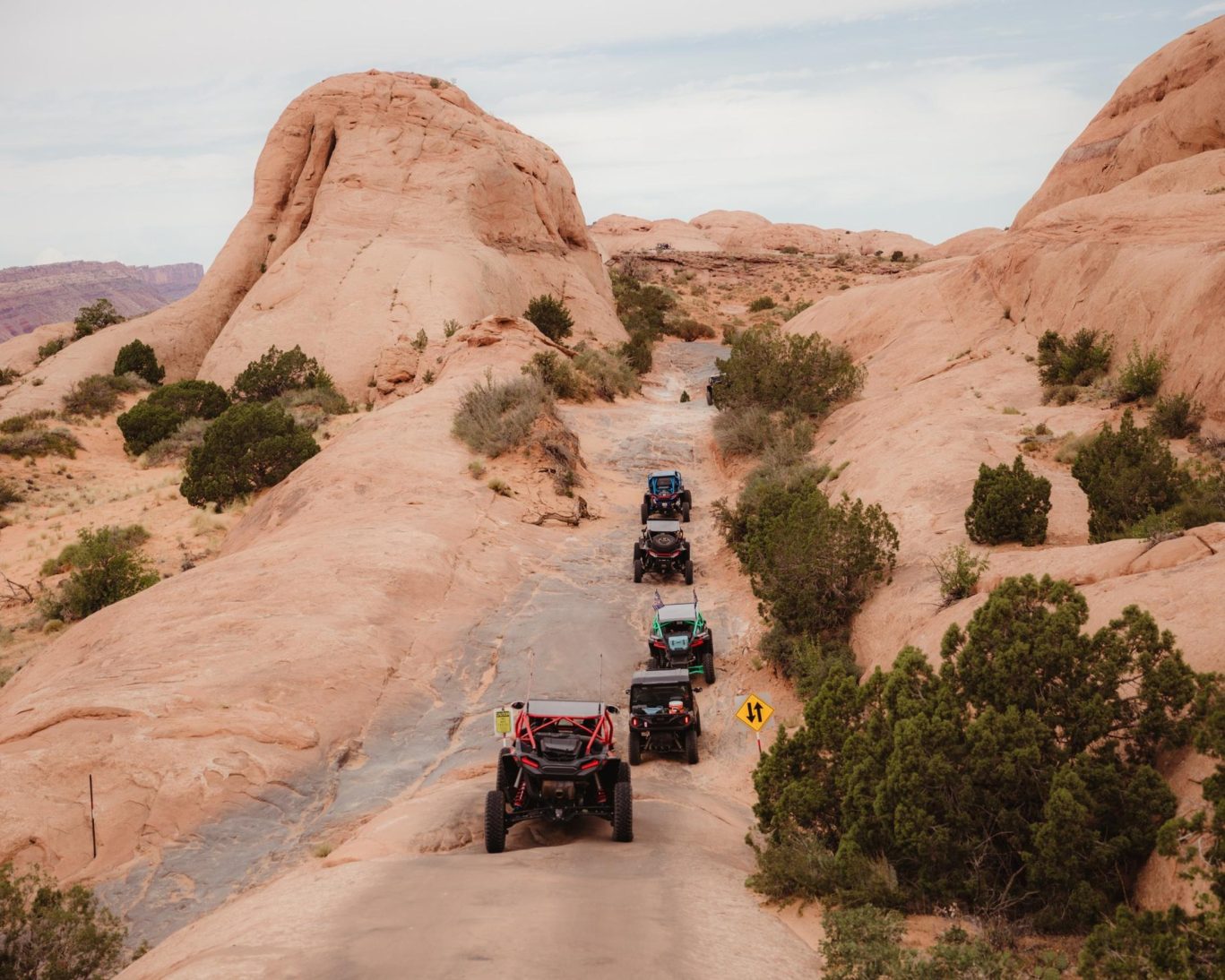 ATVs exploring the rugged red rock terrain of the Burr Trail near Ticaboo, Utah.