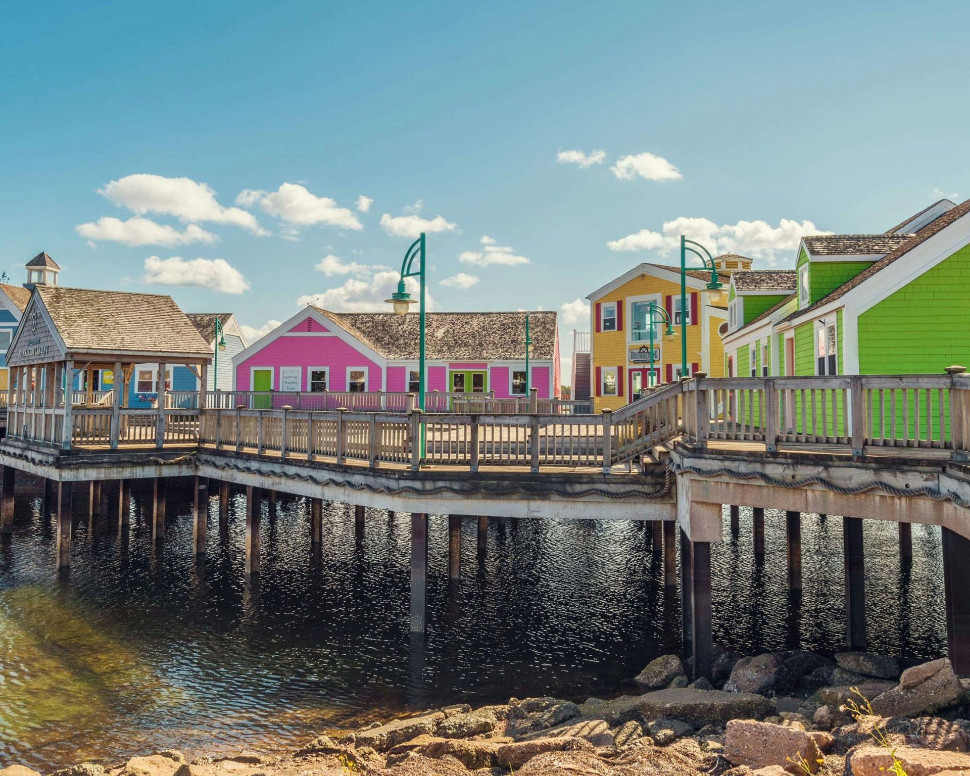 Colorful waterfront shops and boardwalk at Spinnakers' Landing near Travellers Inn in Summerside, PEI.