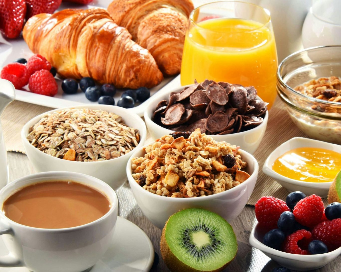 Complimentary continental breakfast spread with granola, fruit, croissants, and coffee at Western Motel.