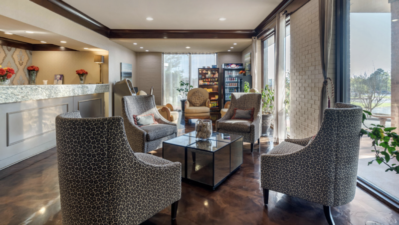 Bright and welcoming hotel lobby with stylish seating area and natural light.