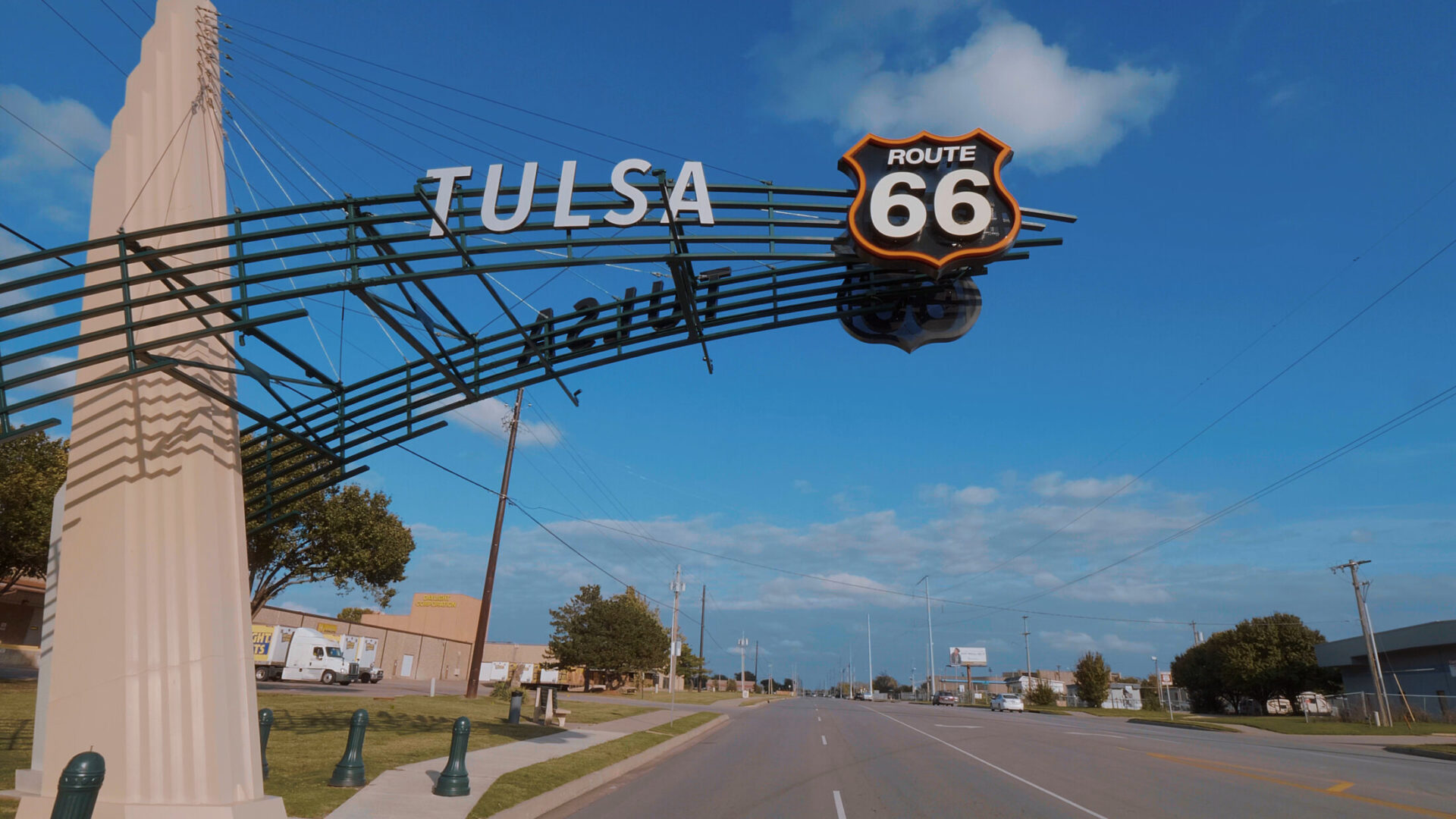 Historic Route 66 sign over street in Tulsa, Oklahoma with blue sky background